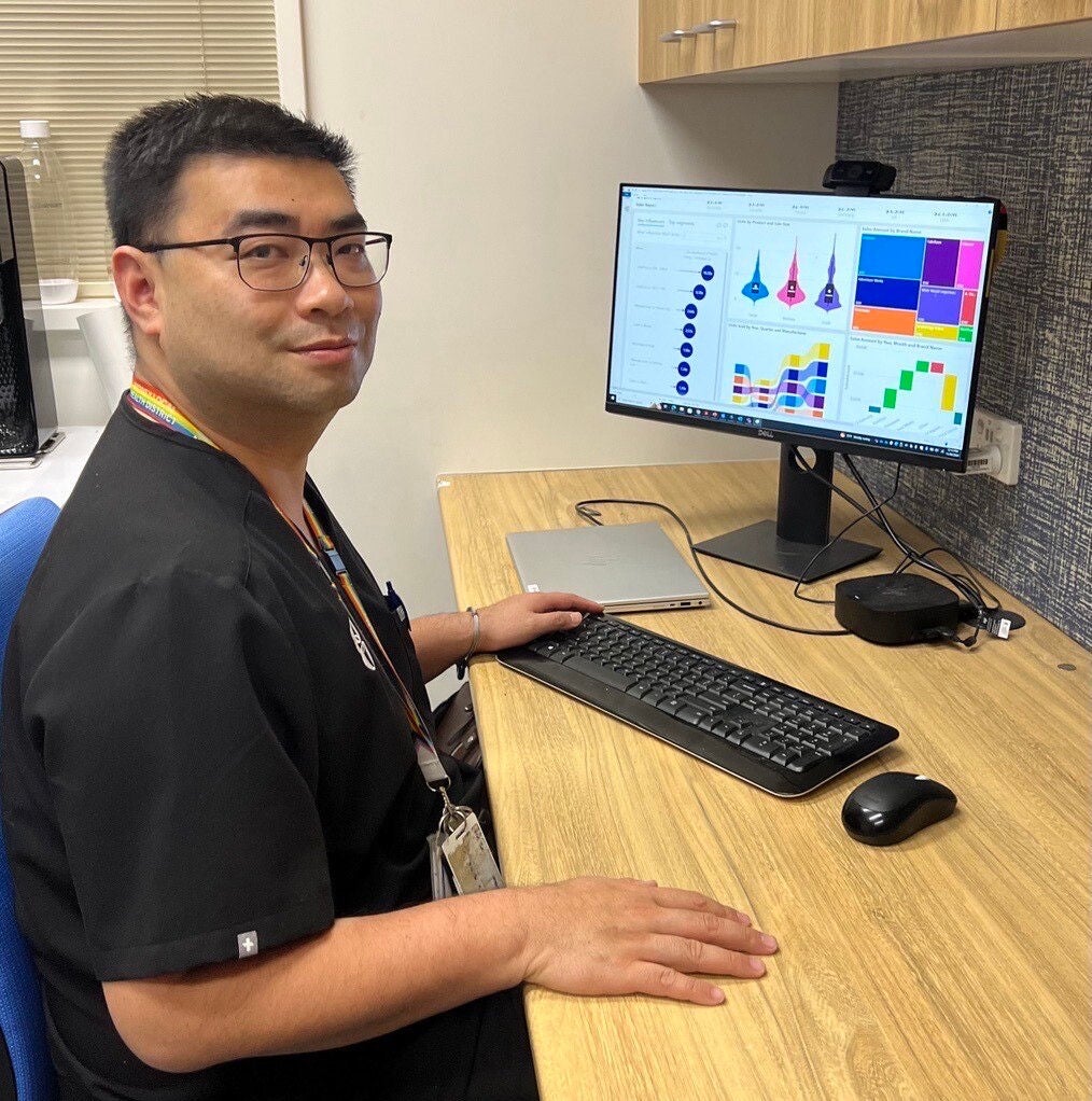 dr ying li sits in front of a computer