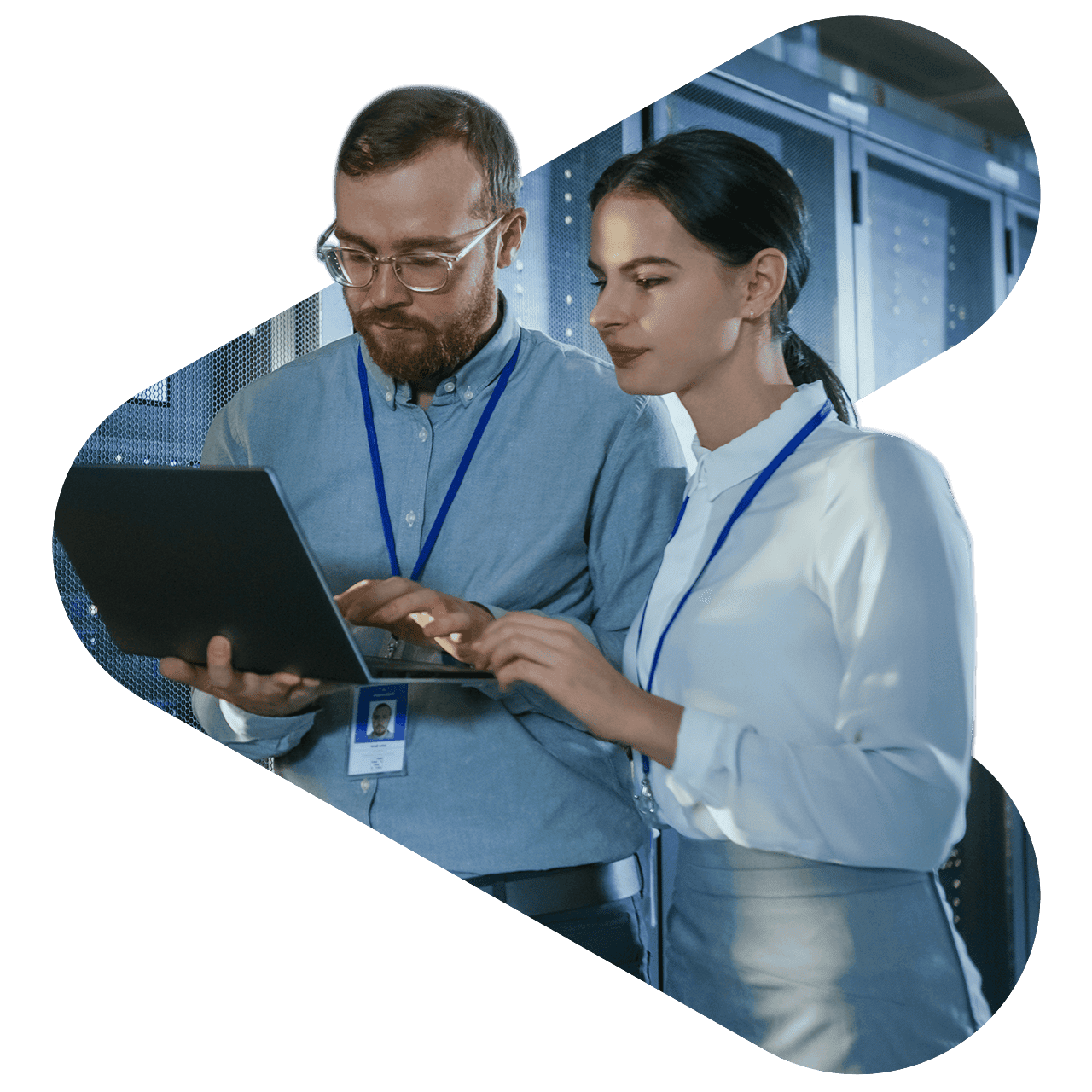 man and woman wearing lanyards working on a laptop