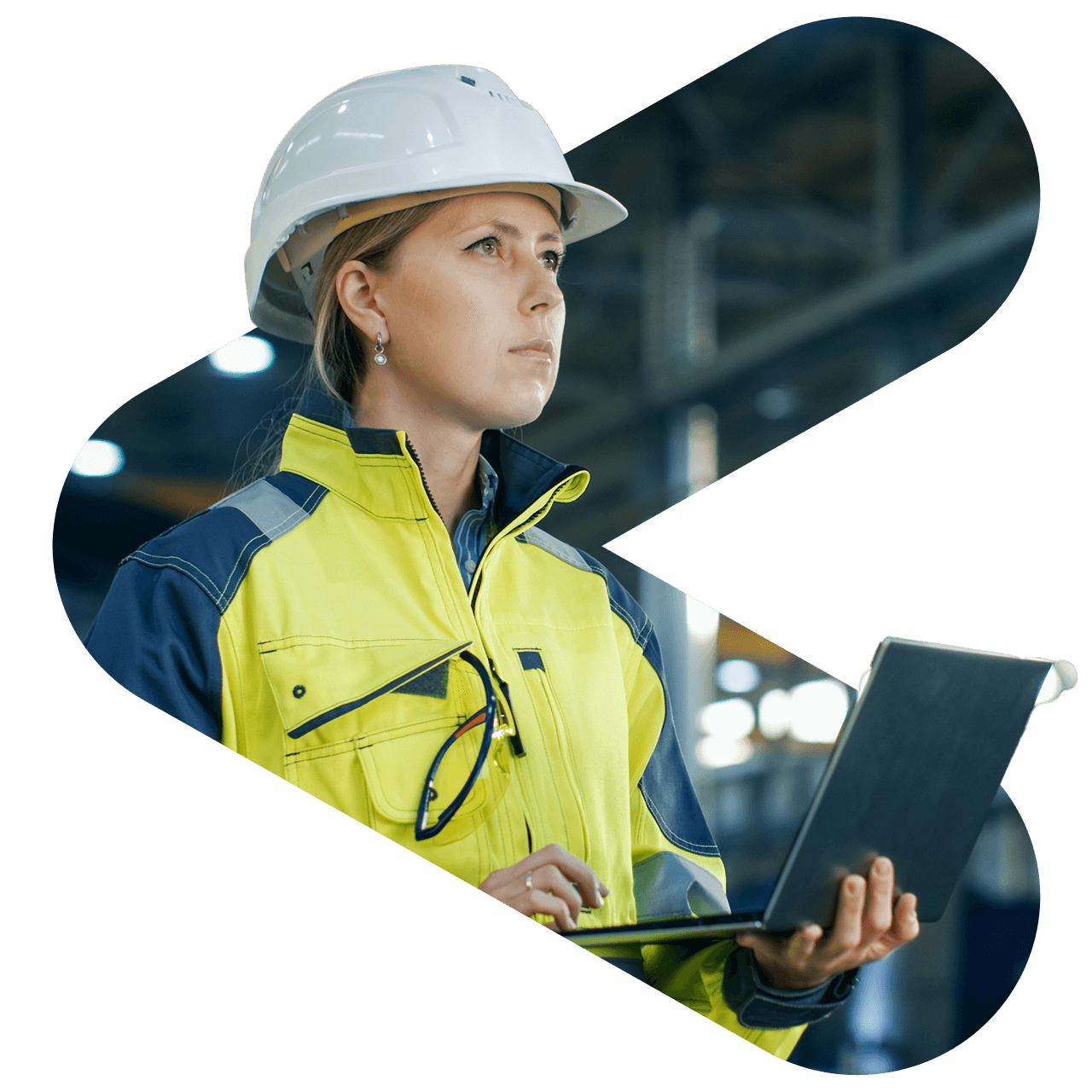 A female engineer wearing a hard hat and high-visibility jacket is using a laptop in an industrial setting.