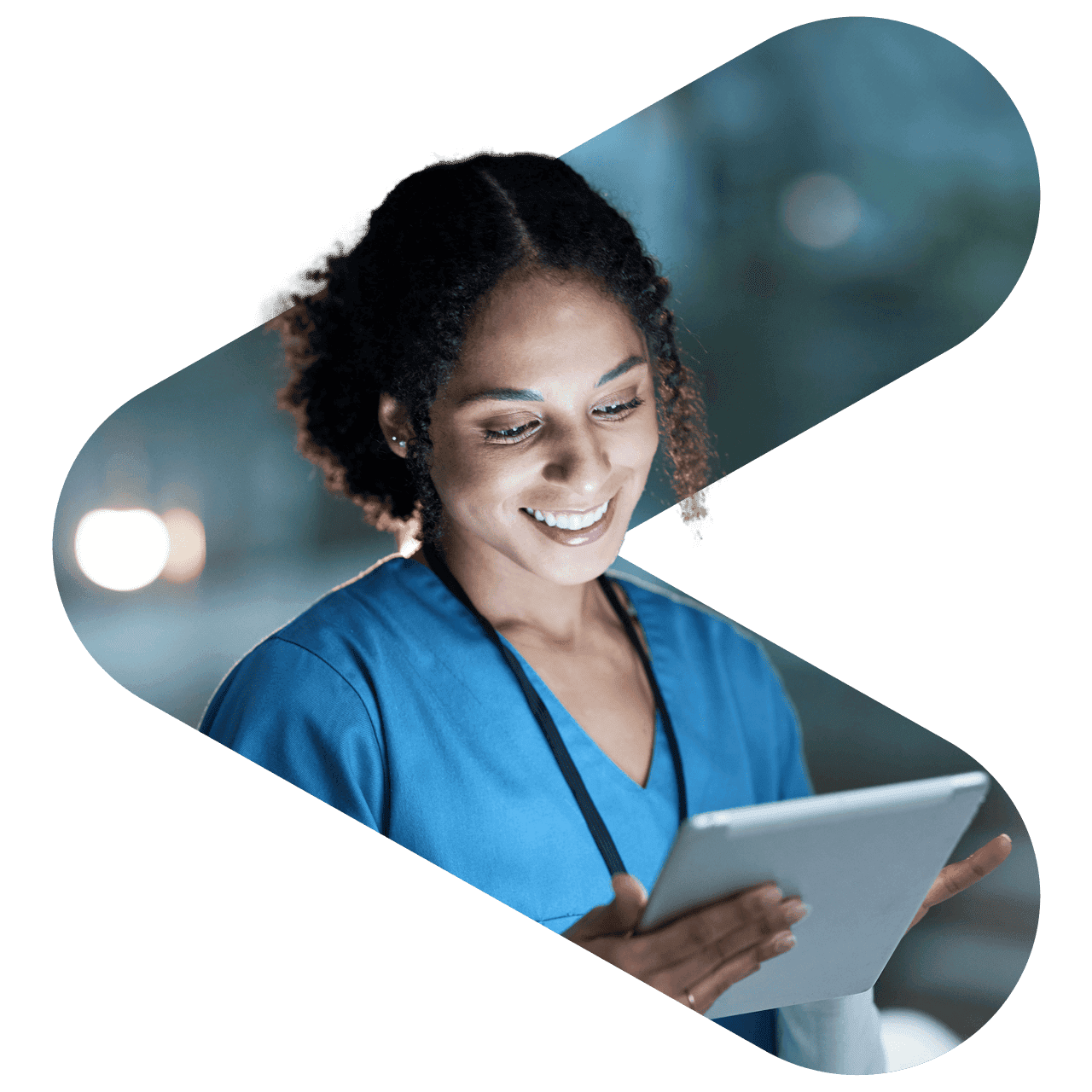 a doctor smiling and looking down at a tablet