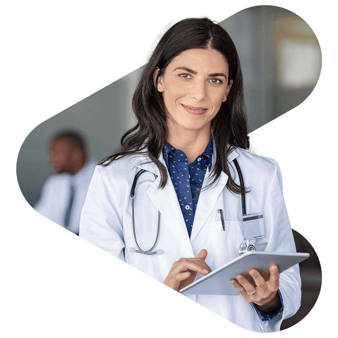 a woman doctor looking at the camera smiling holding a tablet