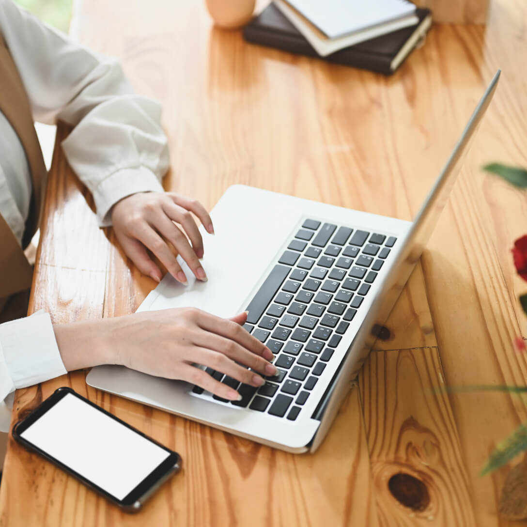 Woman typing on a laptop