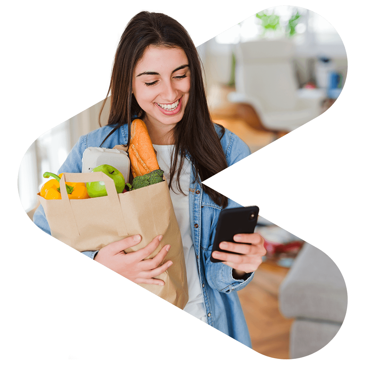 Woman smiling as she receives her groceries after checking the delivery app