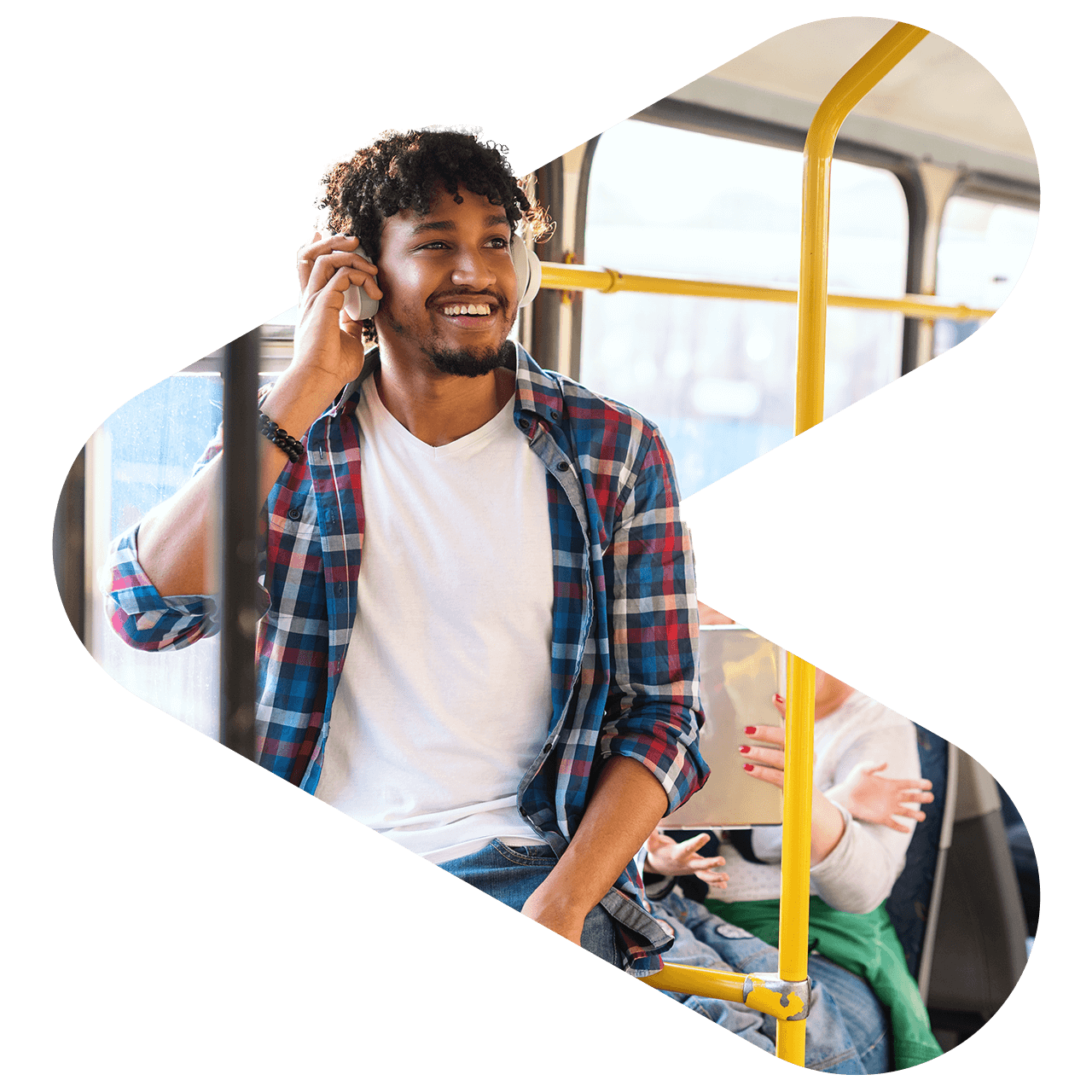 photo of a man riding a public transit bus listening to headphones and smiling