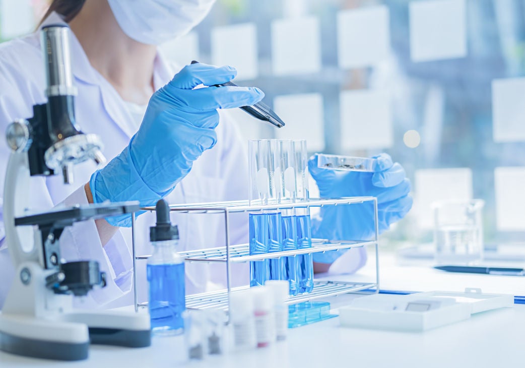 picture of a scientist filling test tubes