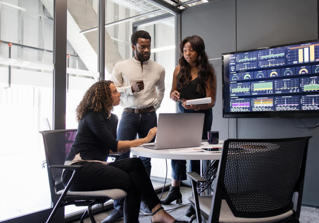 three people in a meeting room