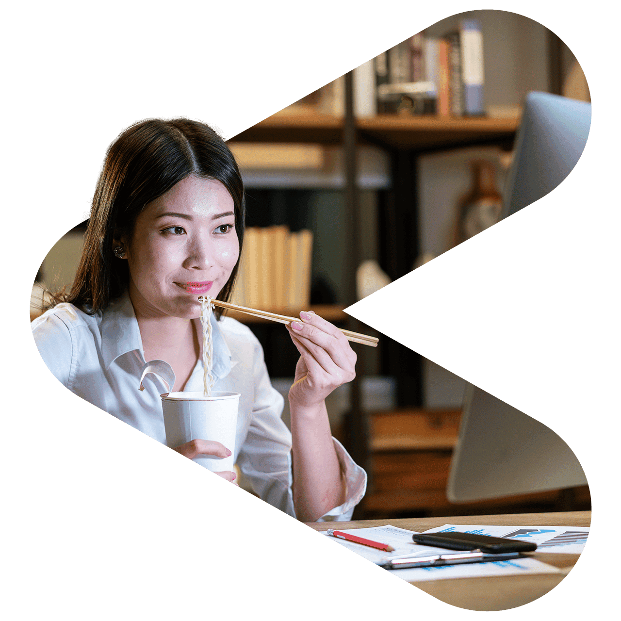 smiling woman eating noodles