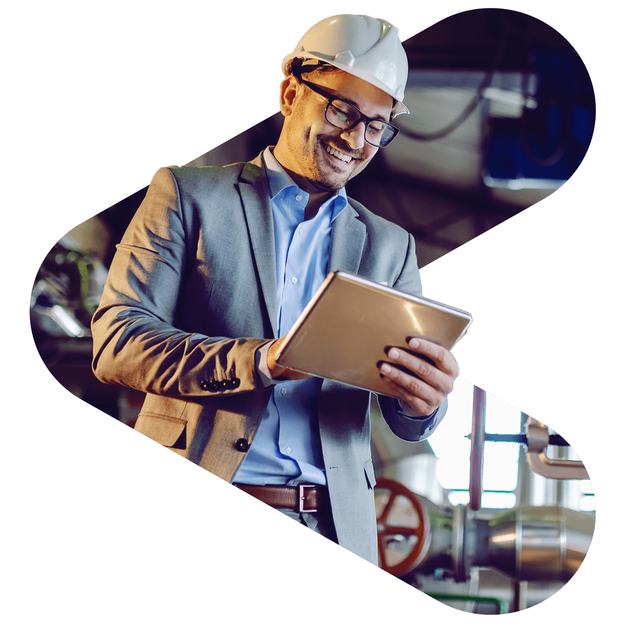 contractor at a factory holding a tablet while smiling